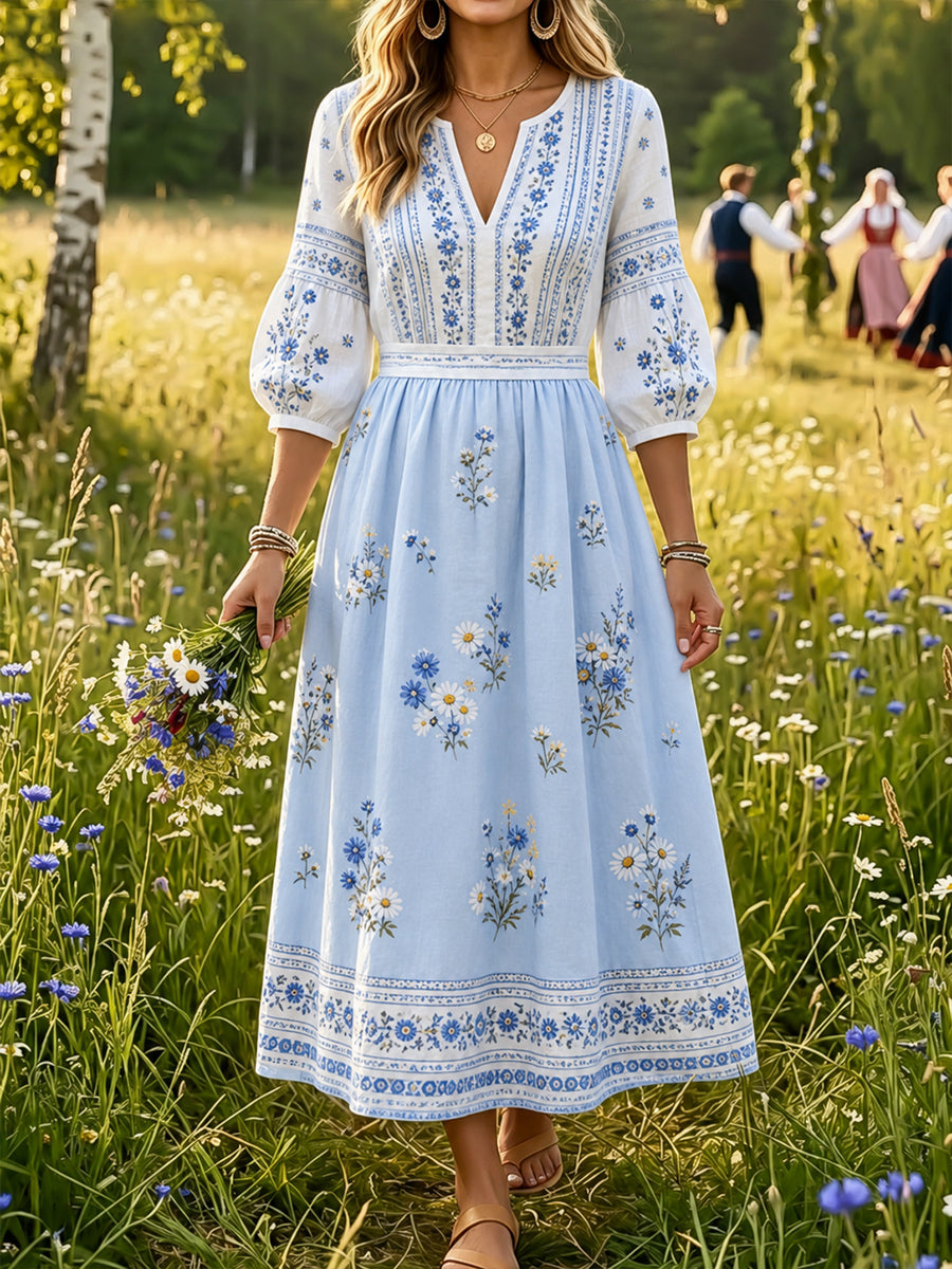 Dammens midsommarklänning med blommönster och v-ringning