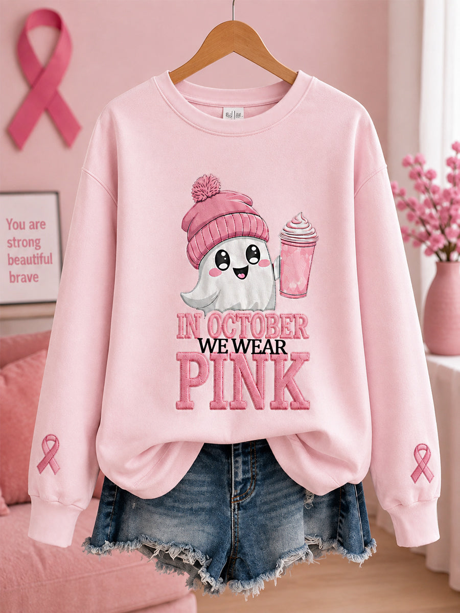 Kvinnors oktoberkläder – rosa sweatshirt med spöktryck, i anslutning till bröstcancerkampanjen