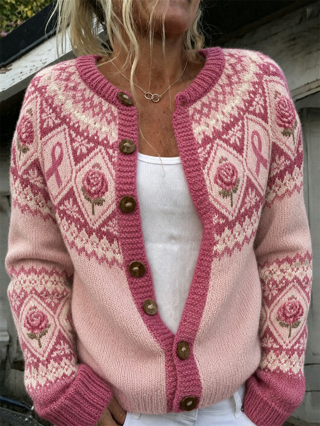 Damjacka i stickat, avslappnad stil, med tryckt mönster med rosa blommor och rosa välgörenhetsband